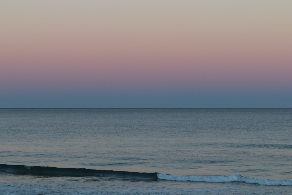 a person riding a surfboard on a wave in the ocean