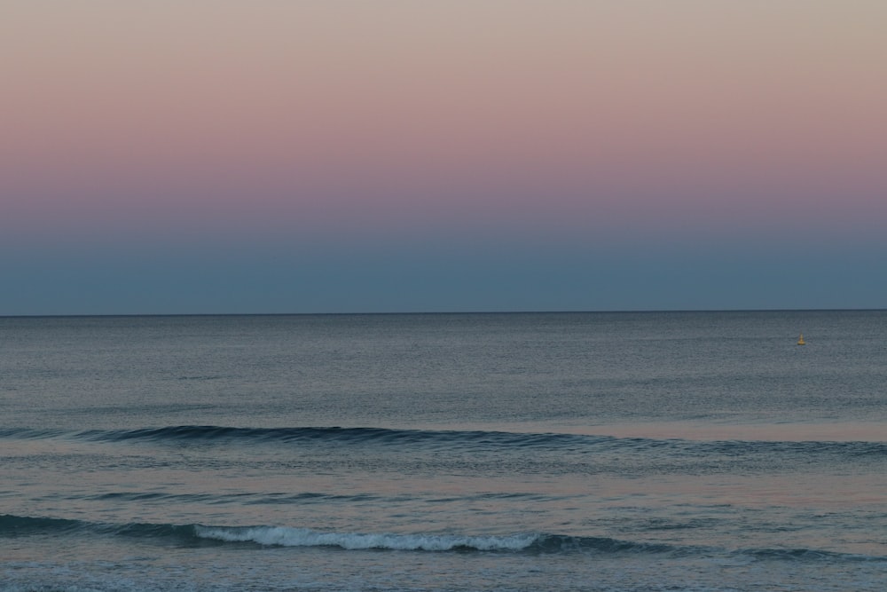 a person riding a surfboard on a wave in the ocean