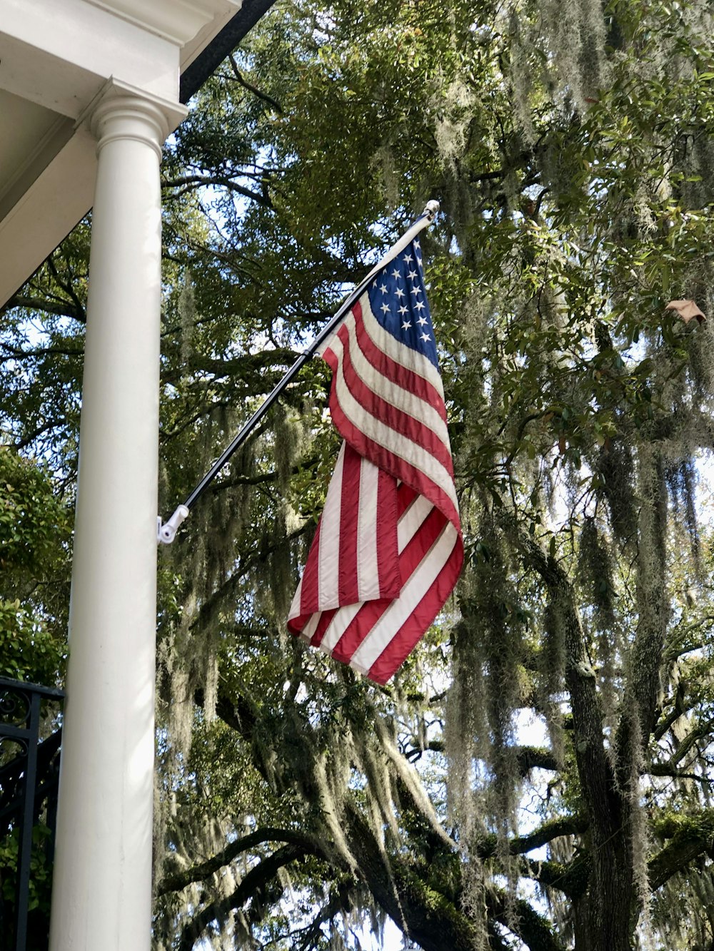 an american flag hanging from the side of a building