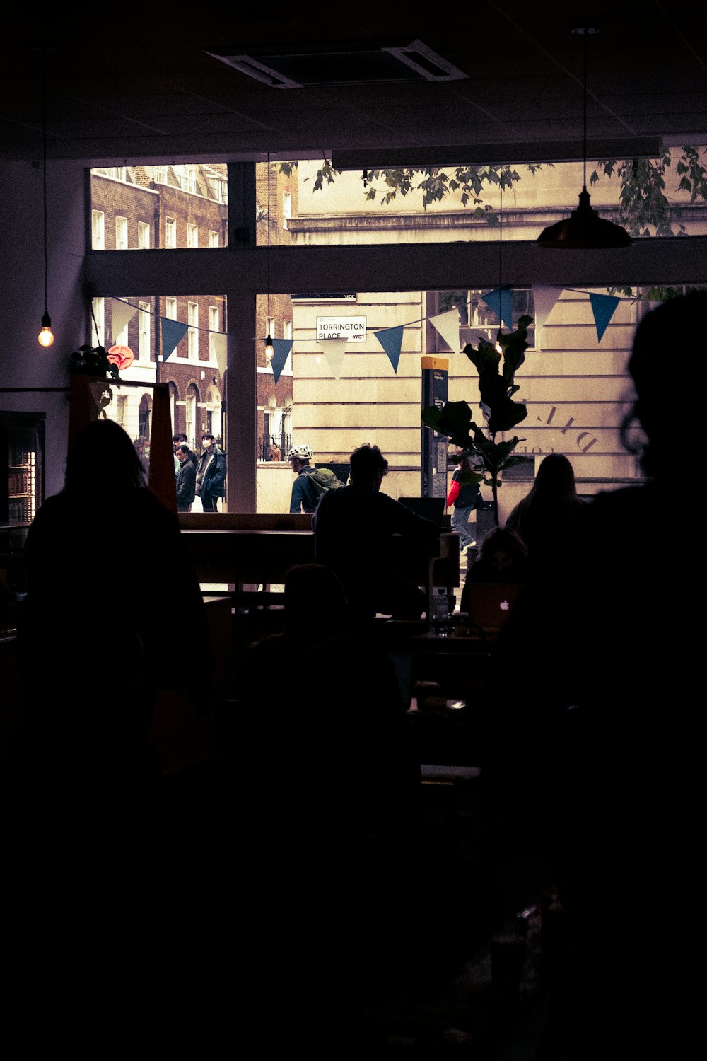 a group of people sitting at a table in front of a window