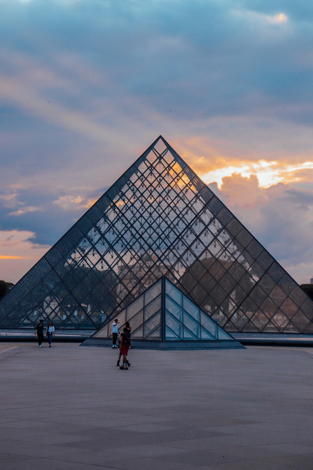 a large pyramid shaped building with a sky background