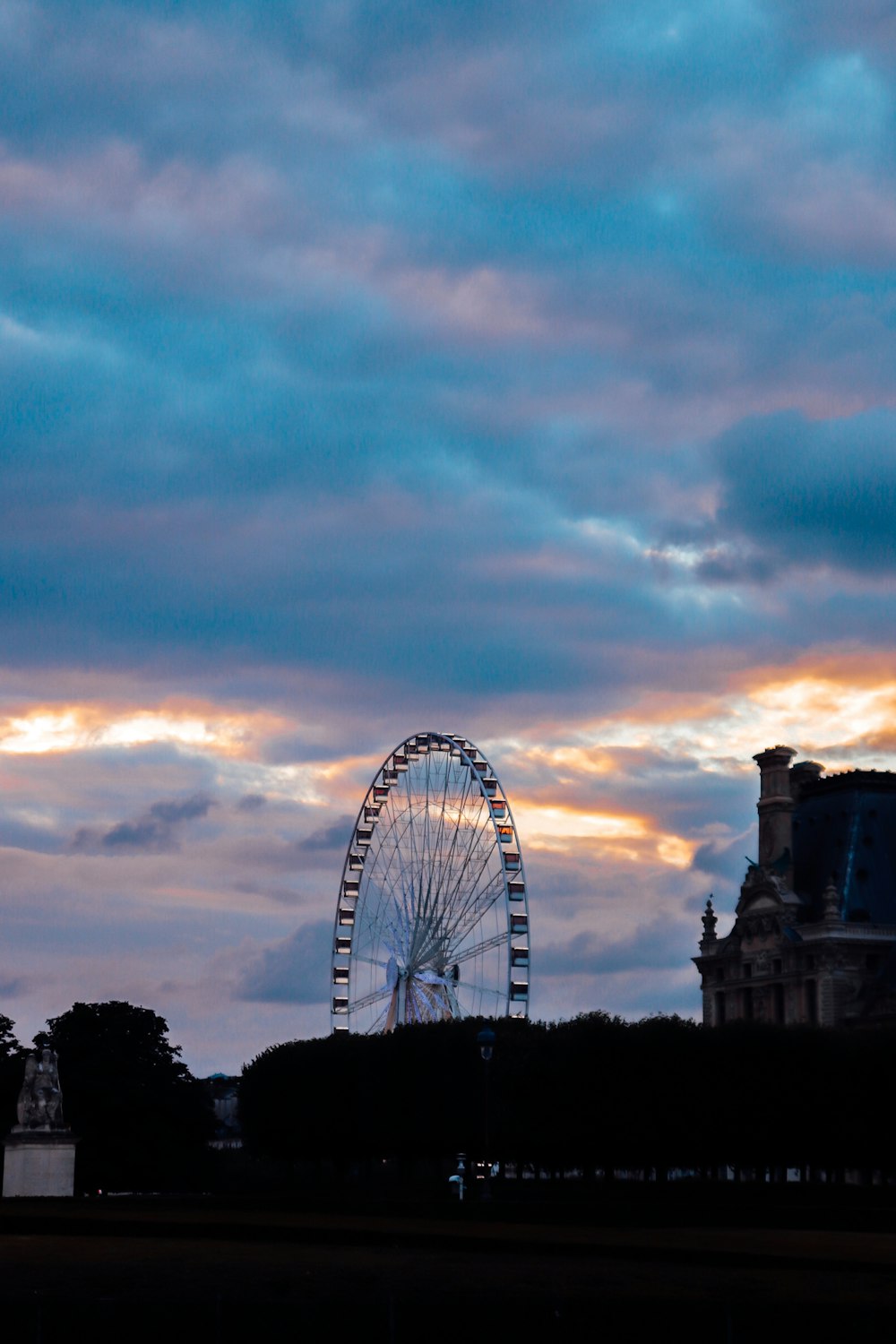 a large ferris wheel sitting next to a tall building