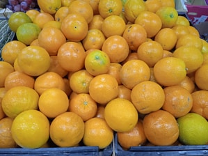 Stacks of fresh Nagpur oranges ready for export in a warehouse.