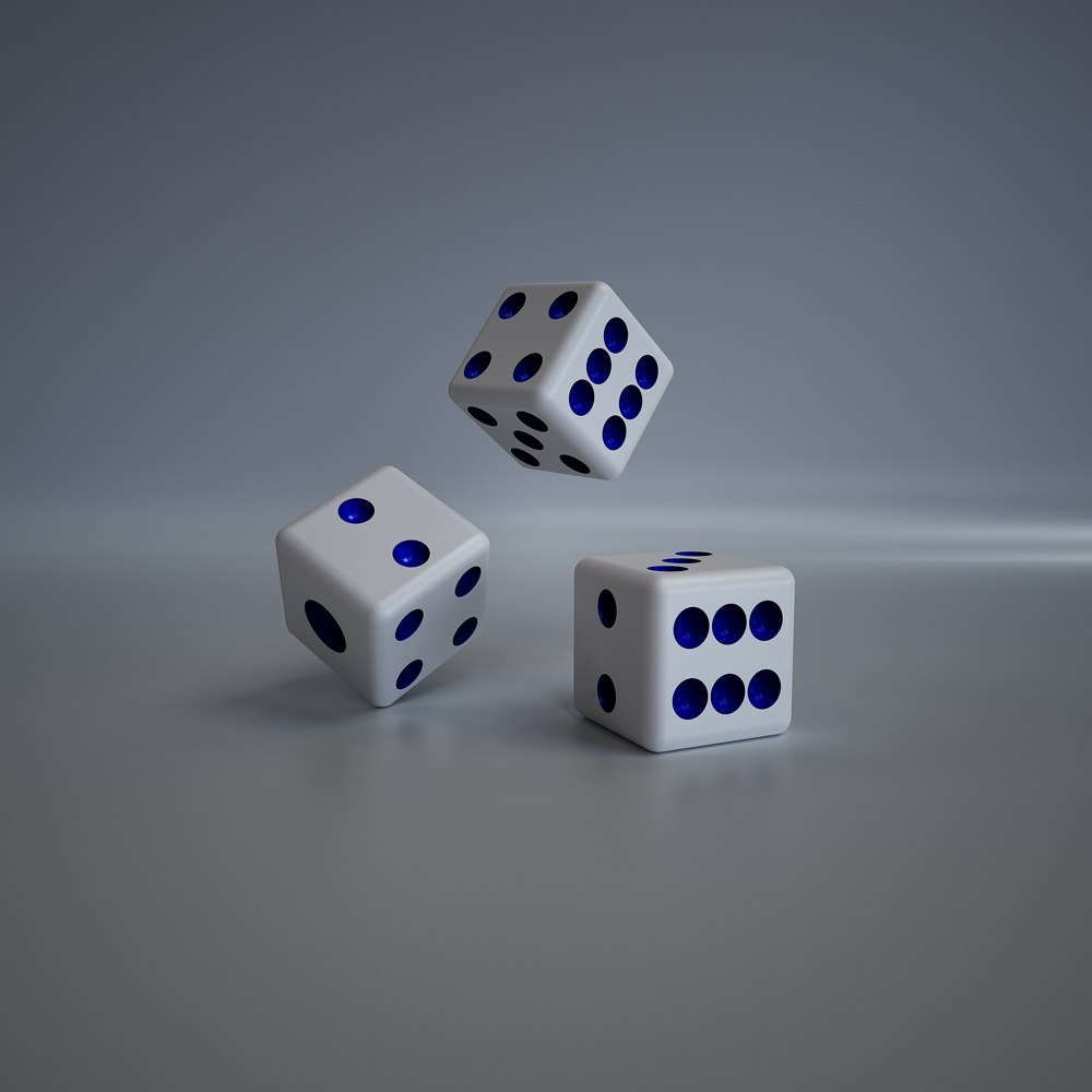 three white dices with blue dots on them