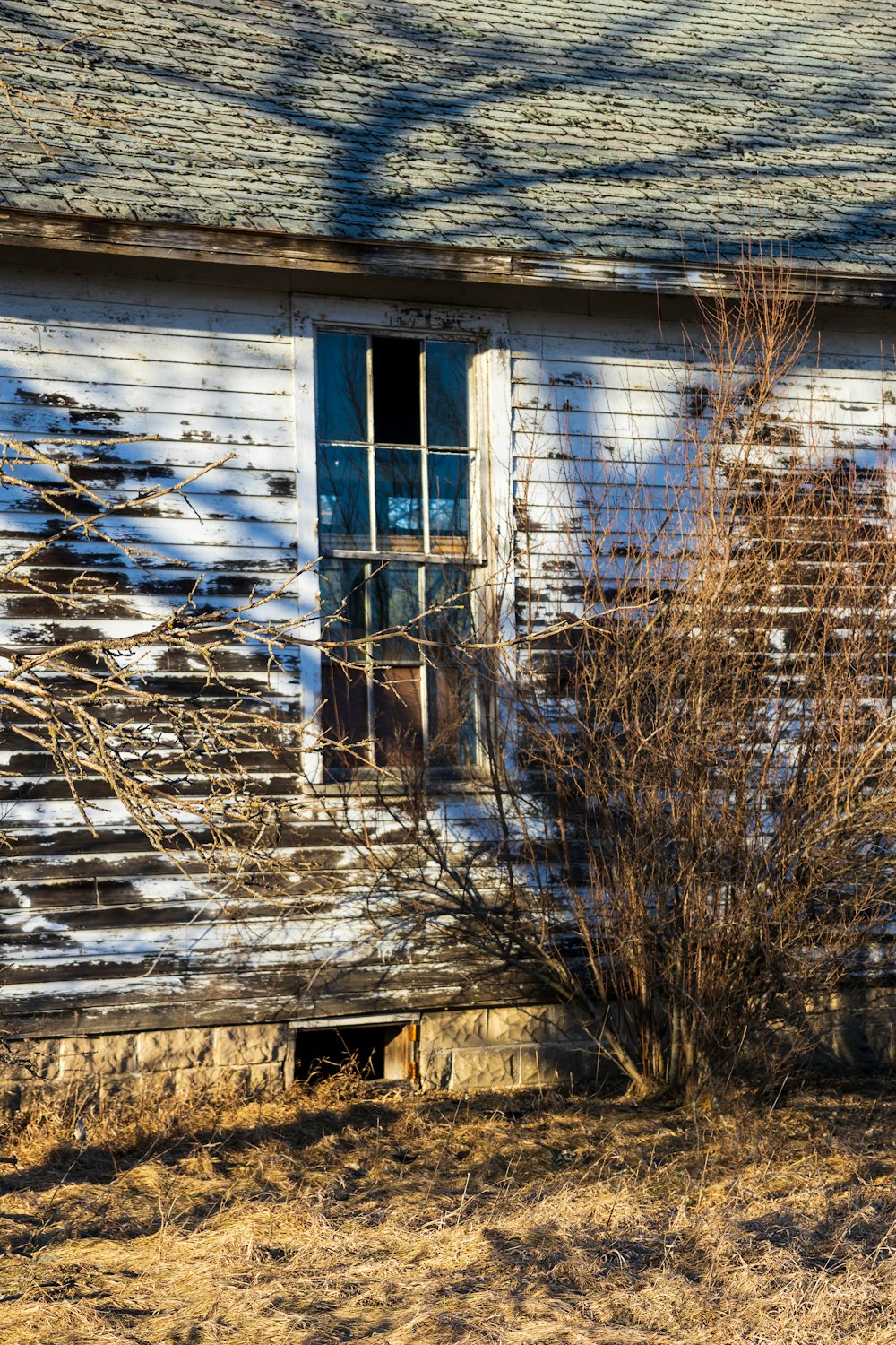 an old run down house with a broken window