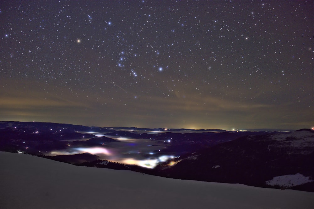 a view of the night sky over a mountain range