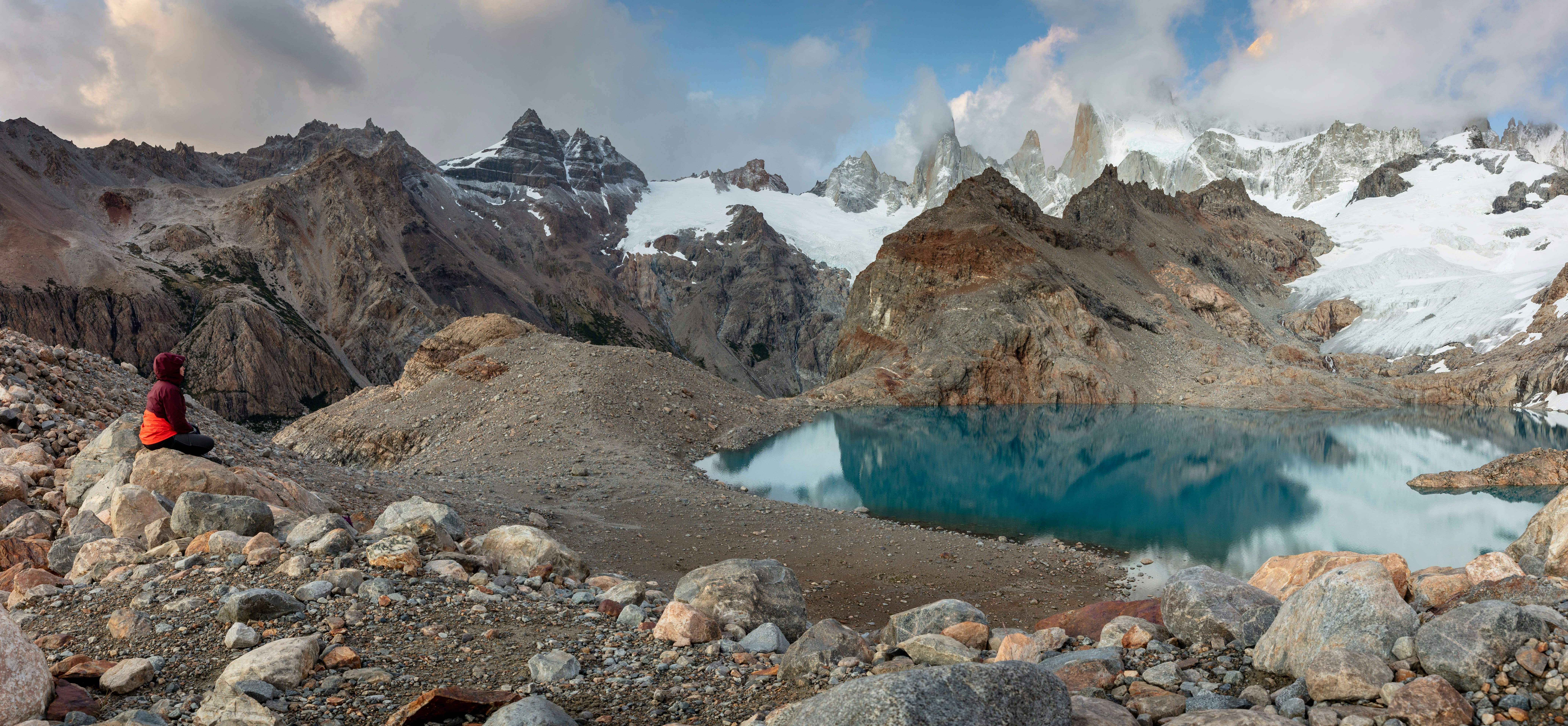 A mountain lake surrounded by rocks and snow