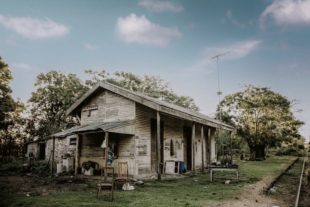 an old run down wooden house with a porch