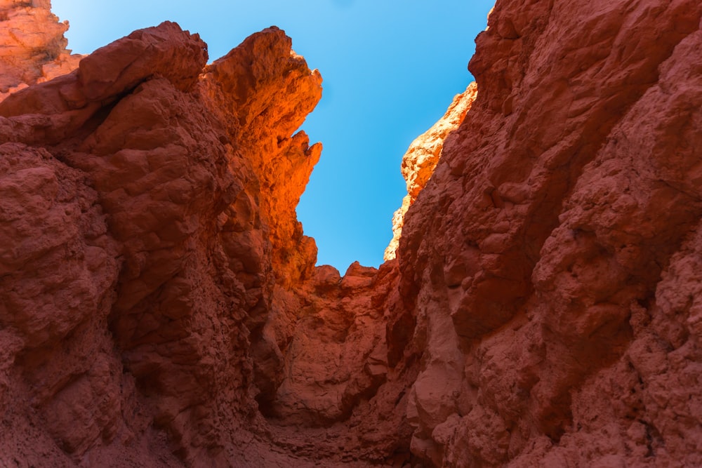 a view of the sky through some rocks