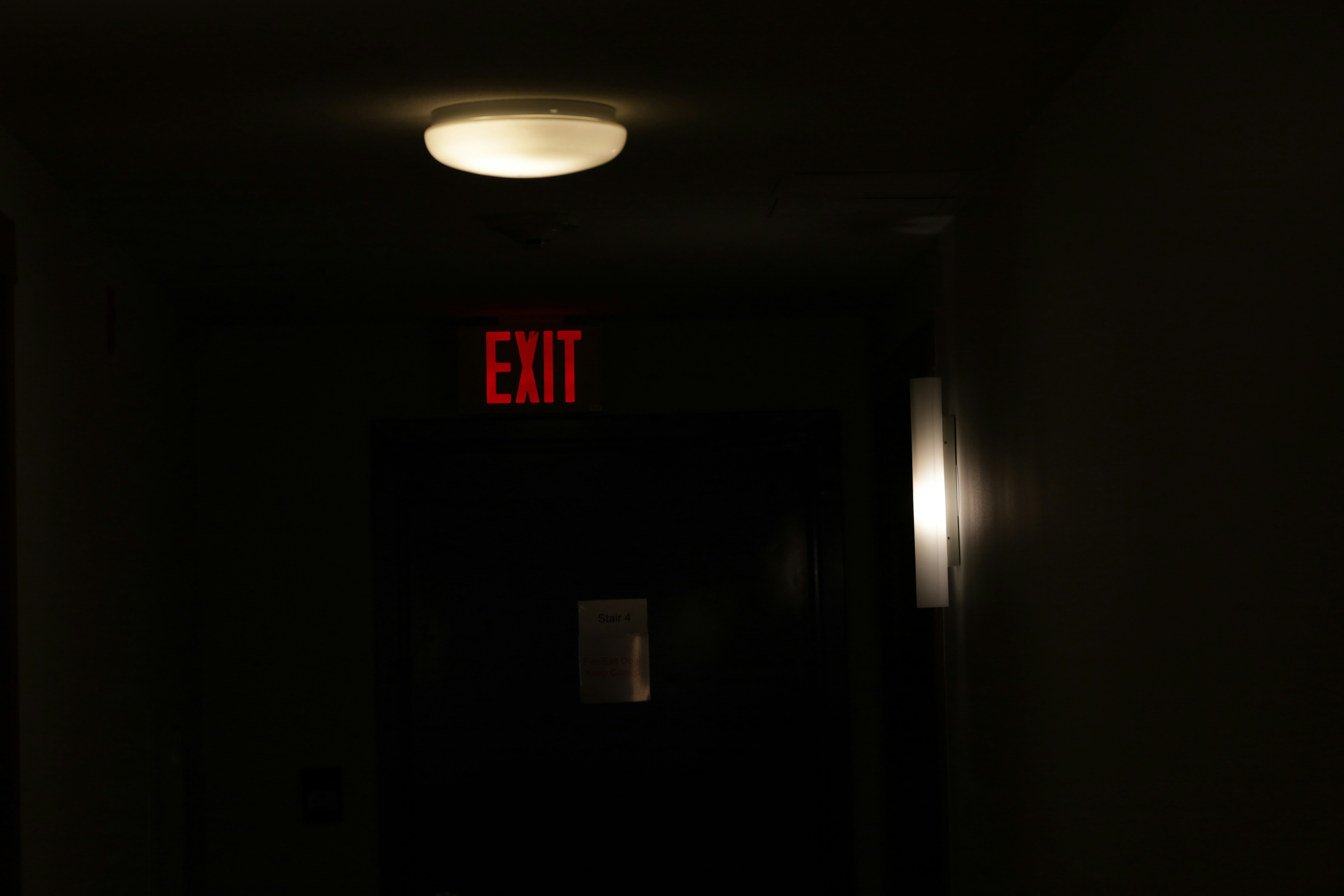 glow-in-the-dark sign in stairwell - entry and exit signs