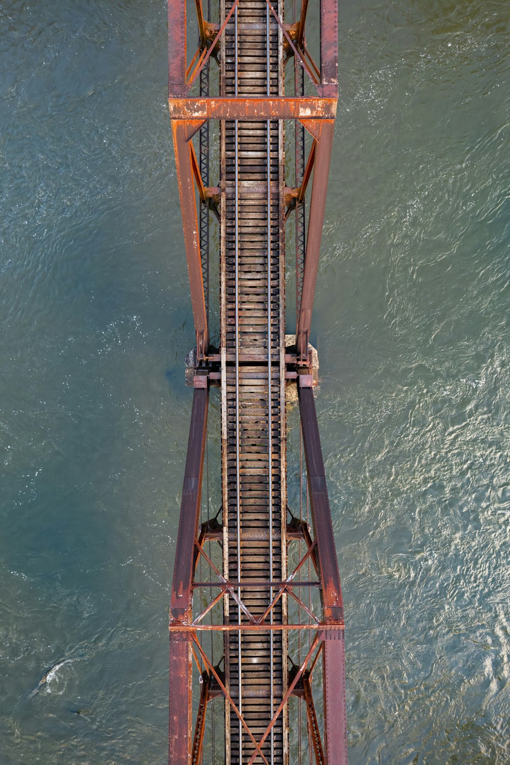 an overhead view of a bridge over a body of water