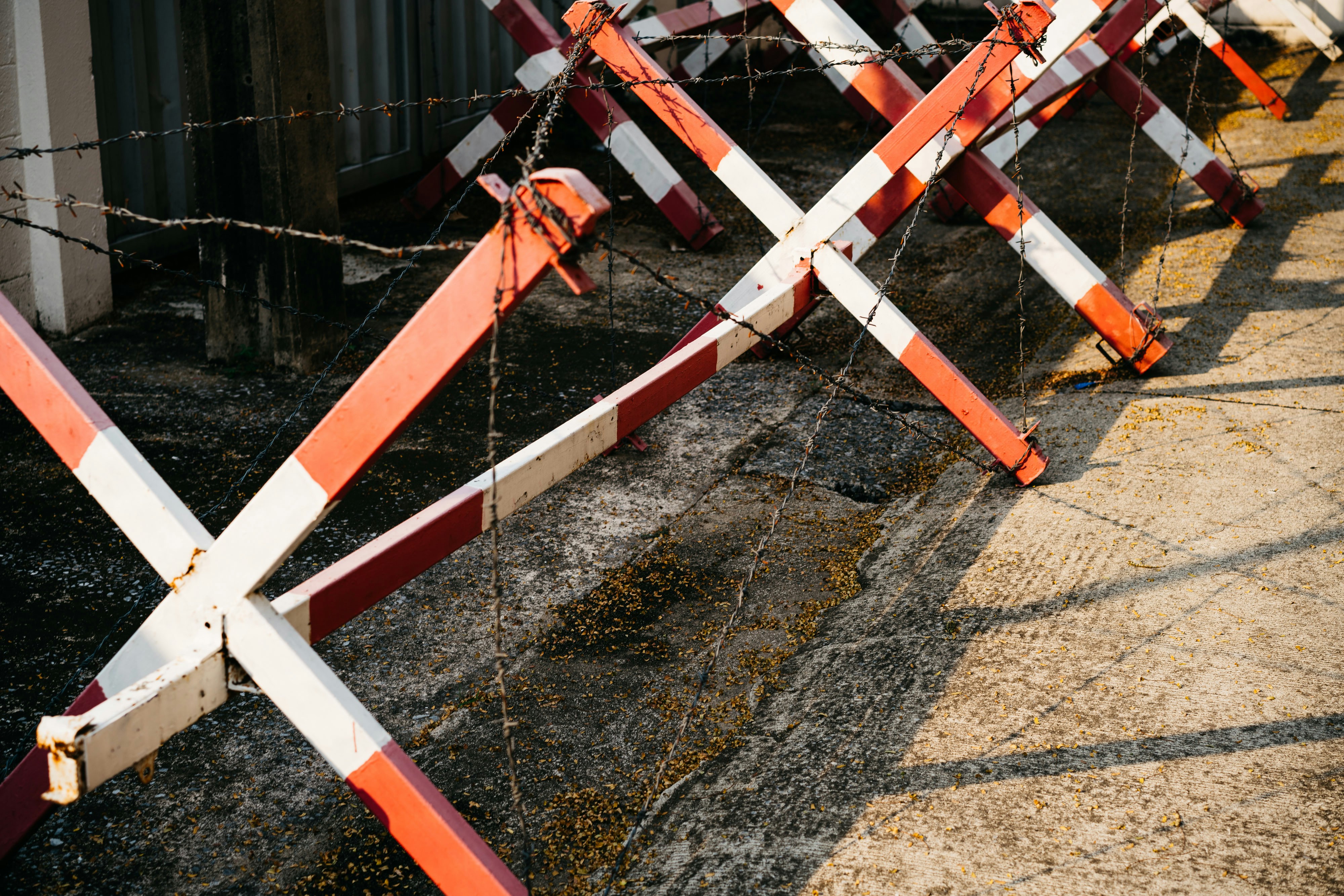 a row of orange and white barriers sitting next to a building