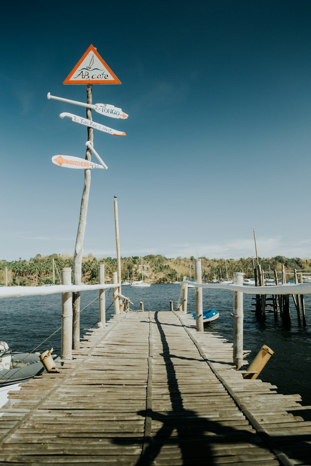 a wooden dock with a sign on top of it