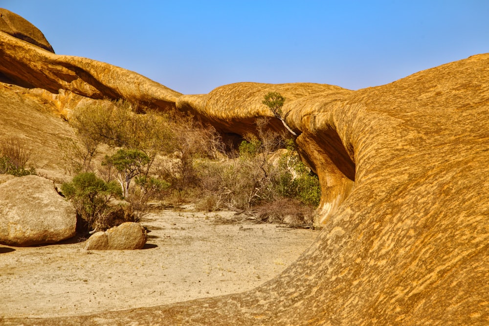 a rock formation in the desert with a blue sky in the background