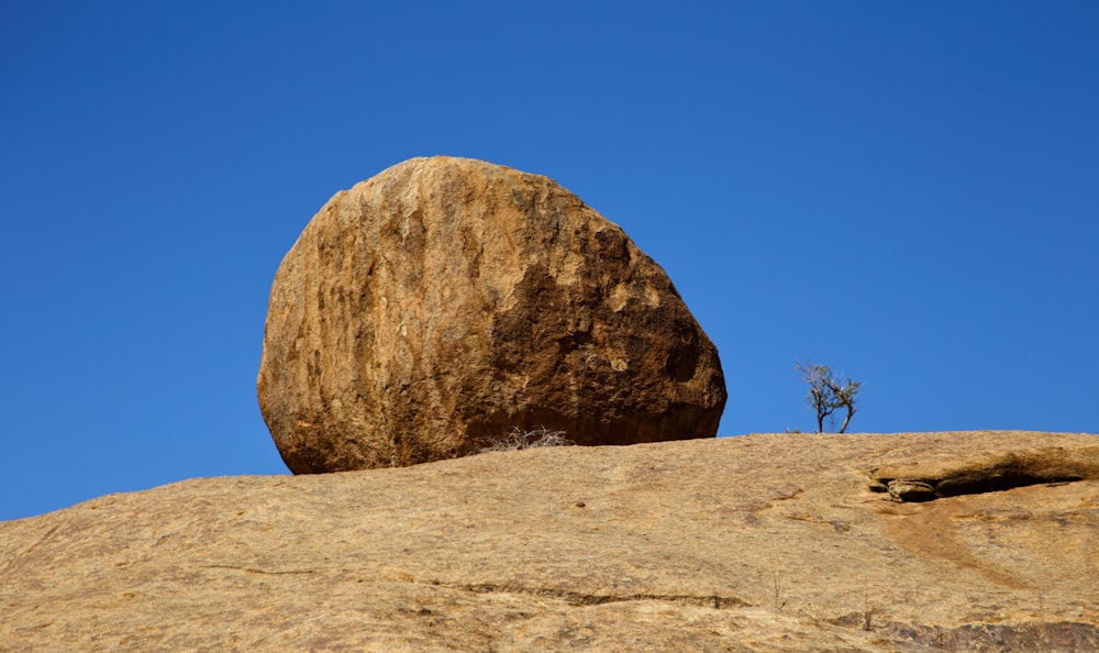 a large rock sitting on top of a large rock