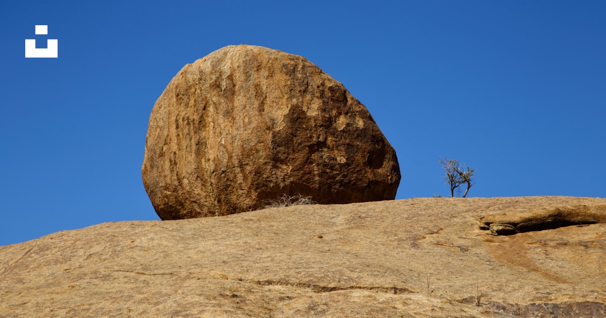 Un gros rocher assis au sommet d’un gros rocher photo – Photo Monts ...