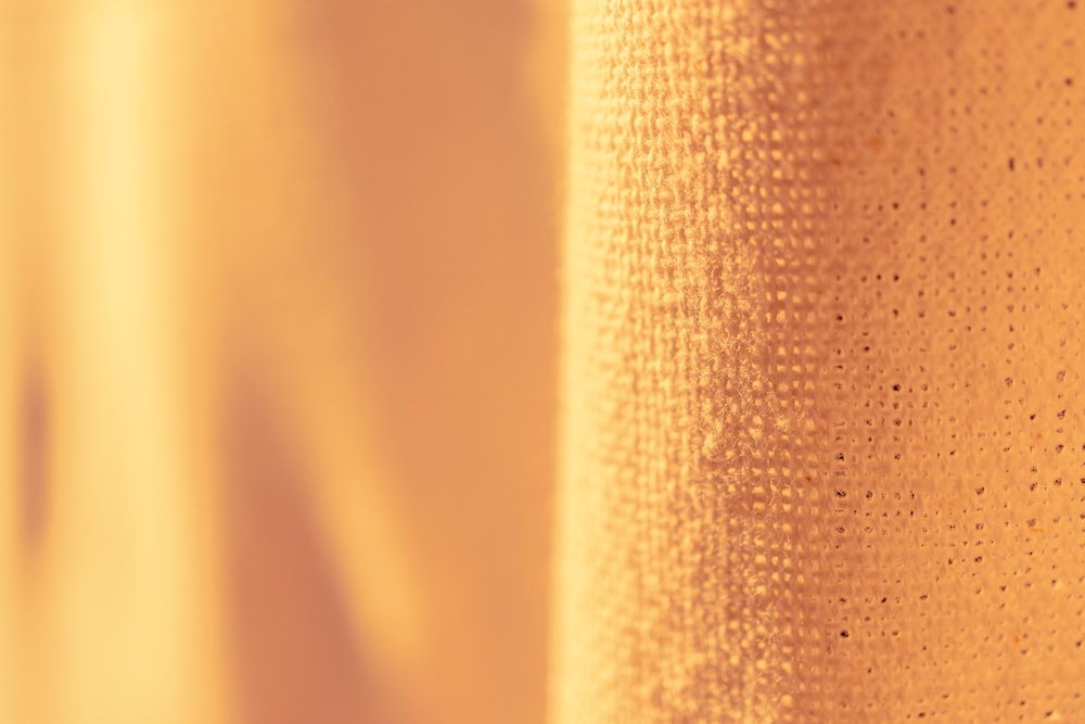 a close up view of a yellow curtain