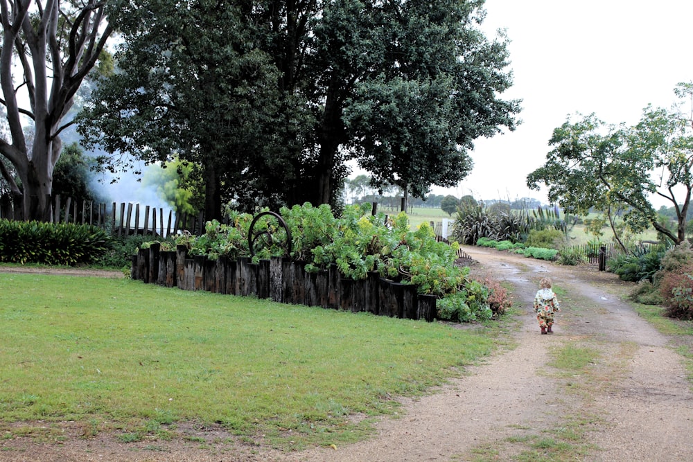 a person riding a bike down a dirt road