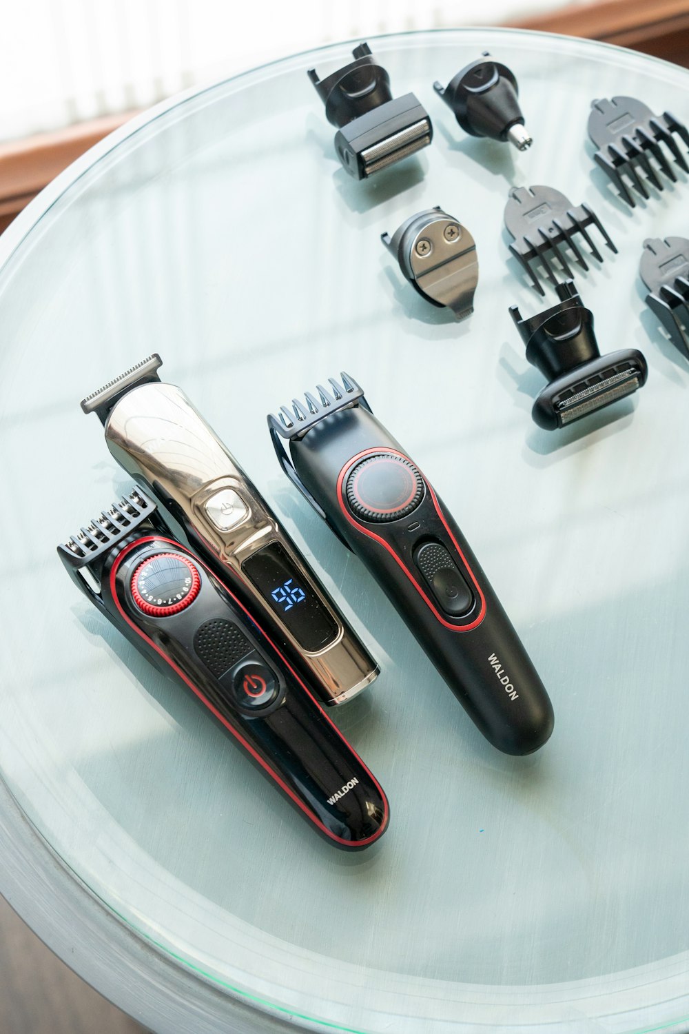 a table topped with different types of hair clippers