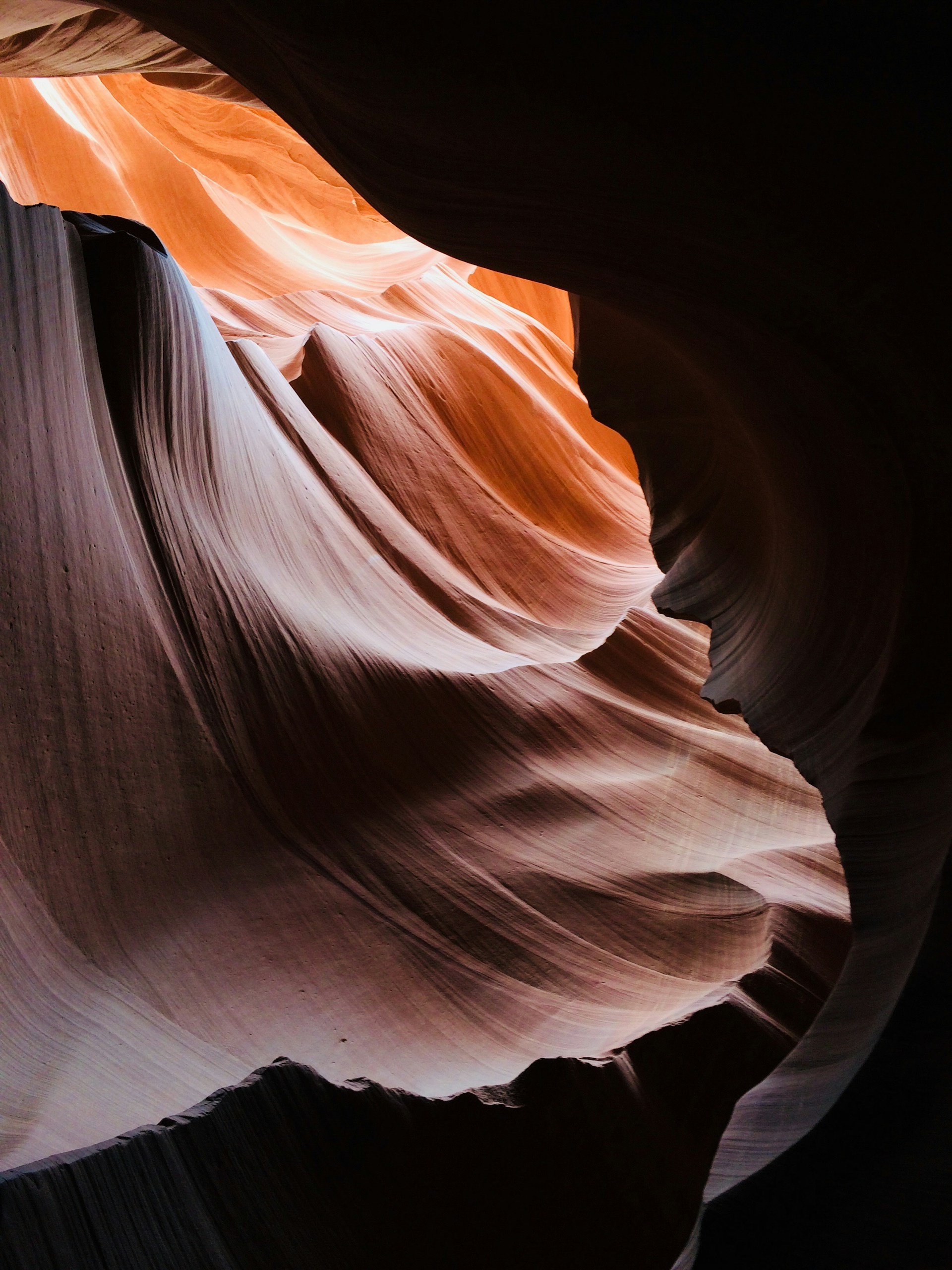 a narrow slot in the side of a rock formation