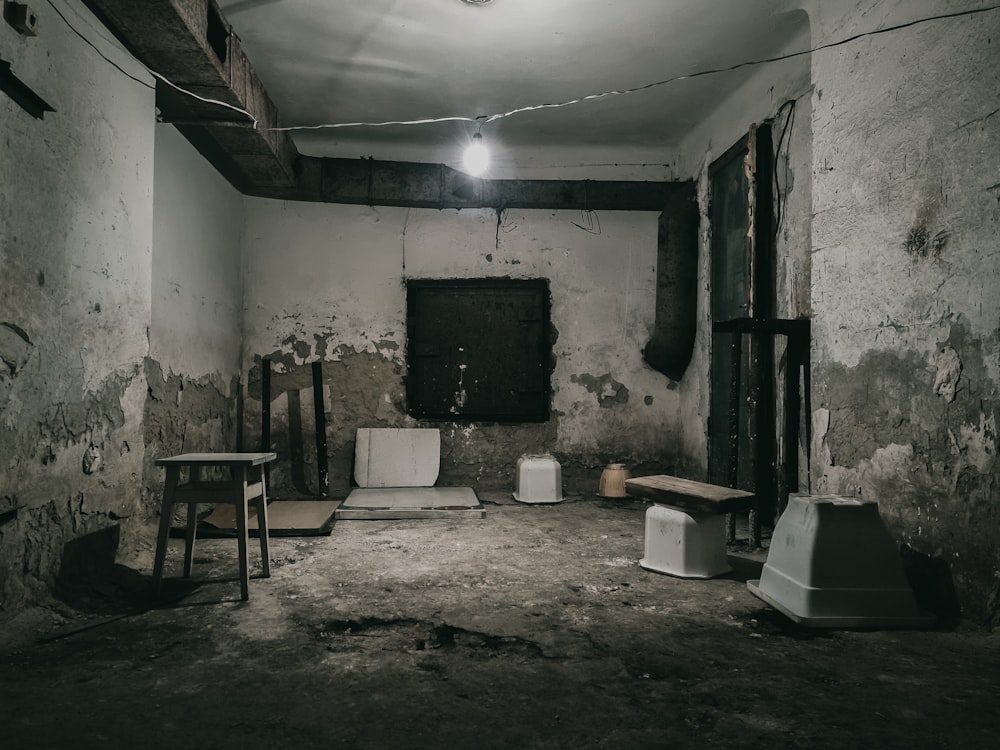 a run down room with two chairs and a table