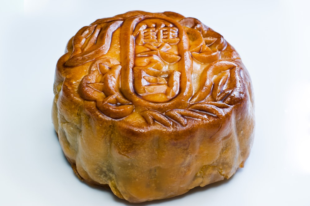 a round cake with writing on it on a white surface