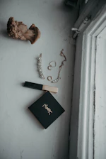 A soft, minimalist flat lay of jm bella’s satin bonnets and stylish hats on a blush background.