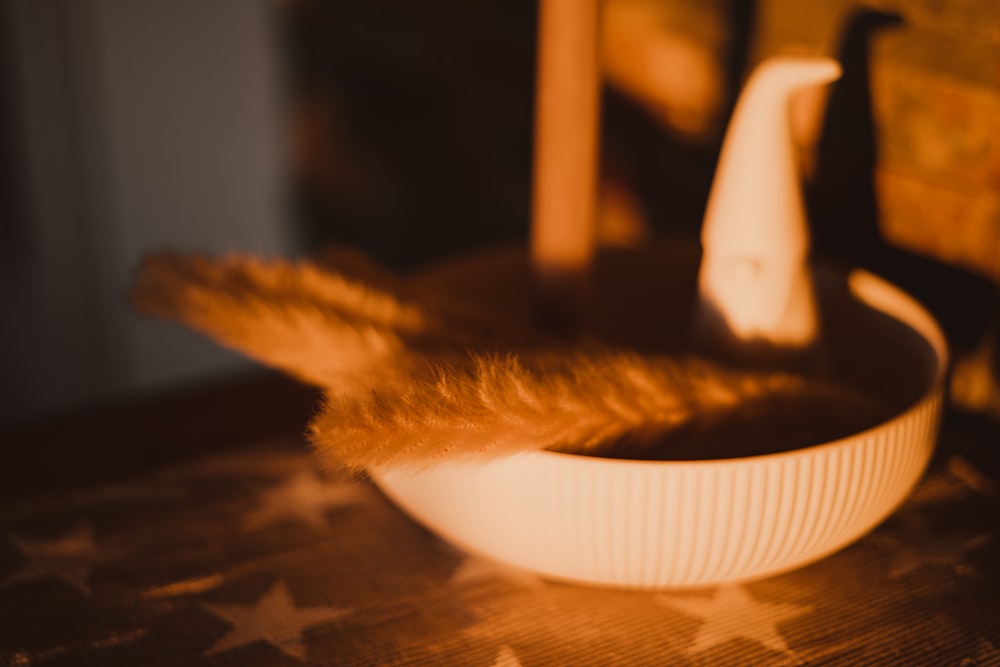 a white bowl sitting on top of a wooden table