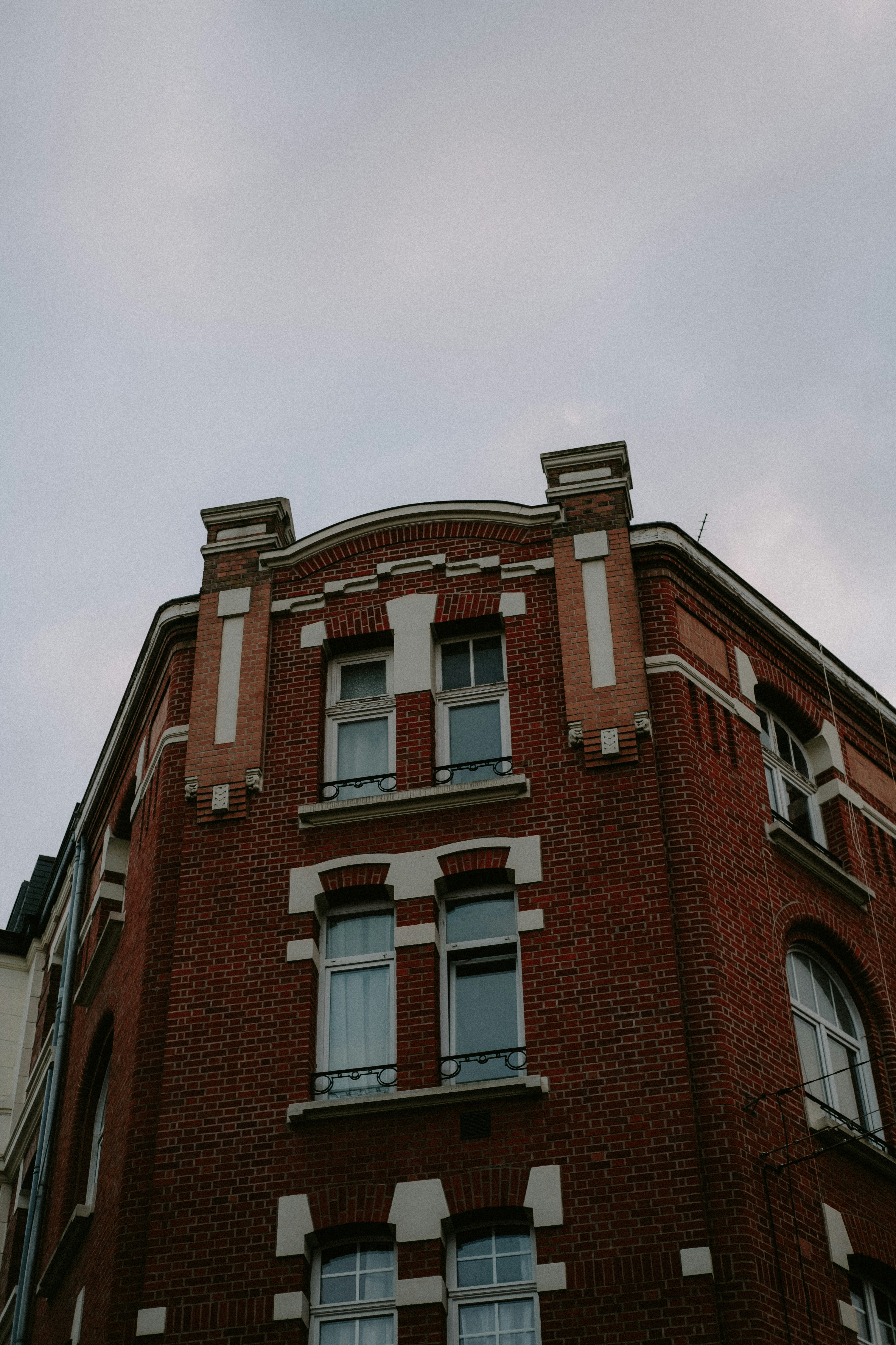 a tall brick building with a clock on the top of it