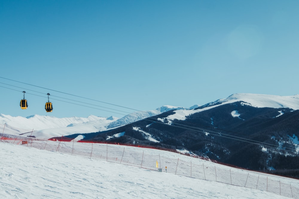 a ski slope with a ski lift in the background