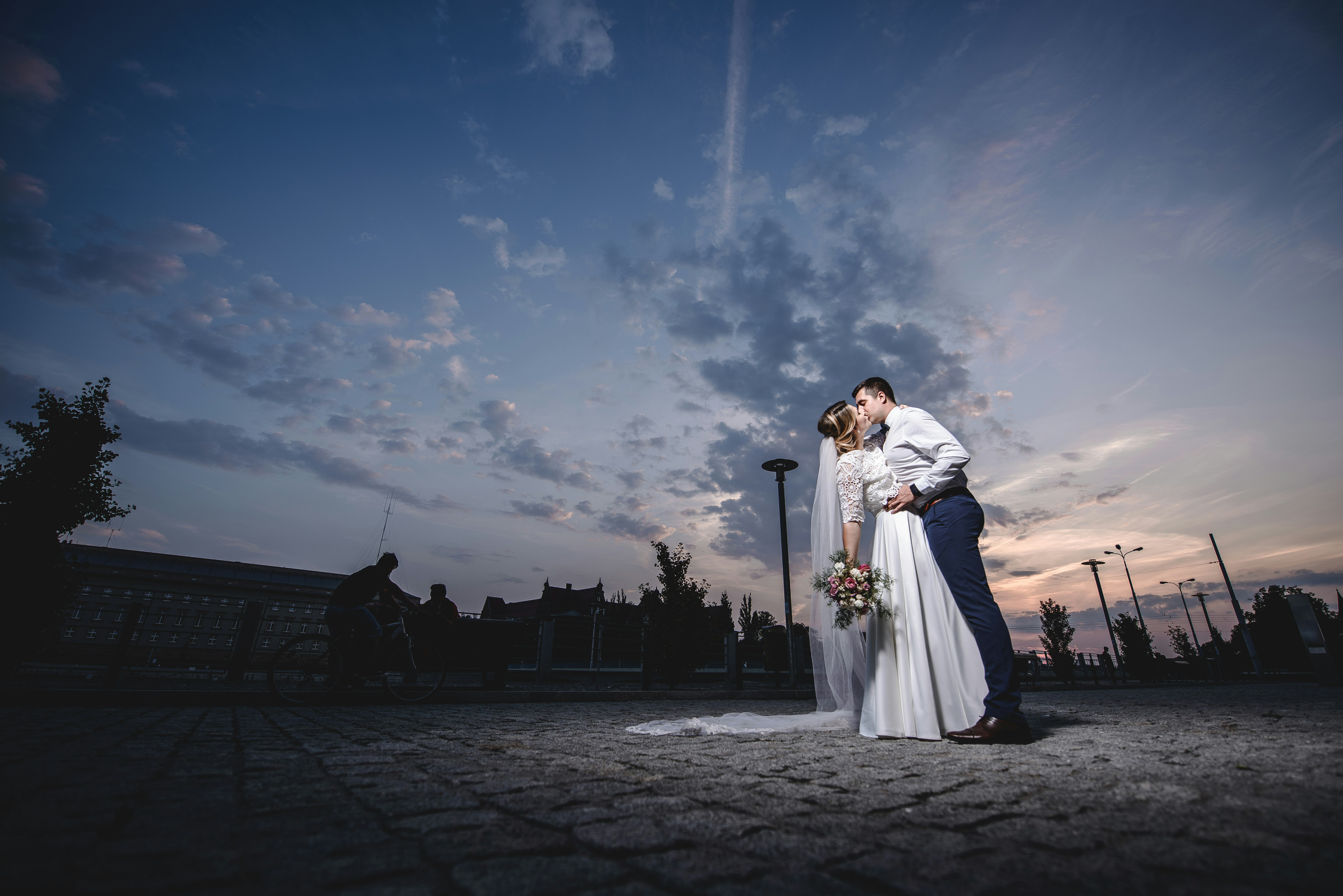 A bride and groom kissing in front of a sunset photo – Free Apparel ...
