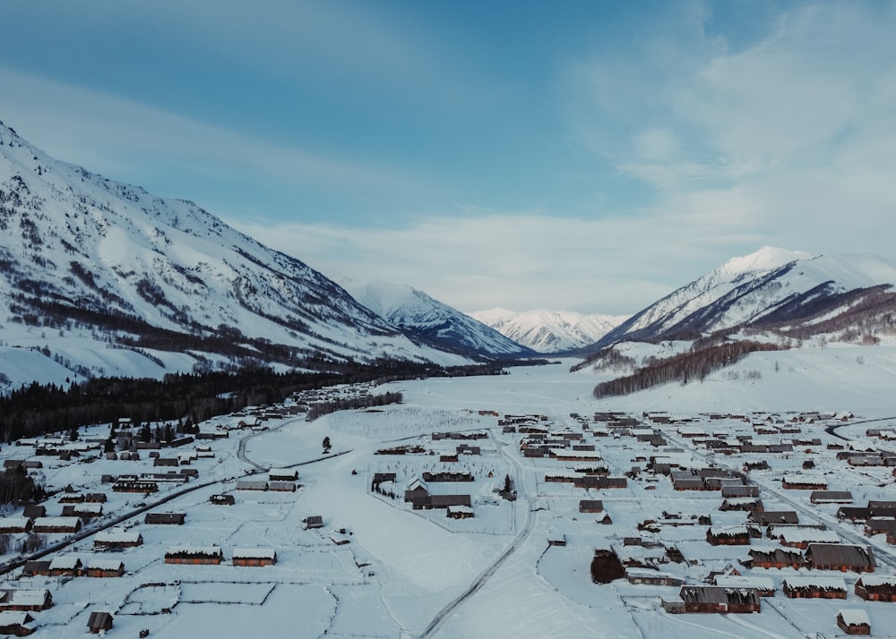 a snow covered town in the middle of a mountain range