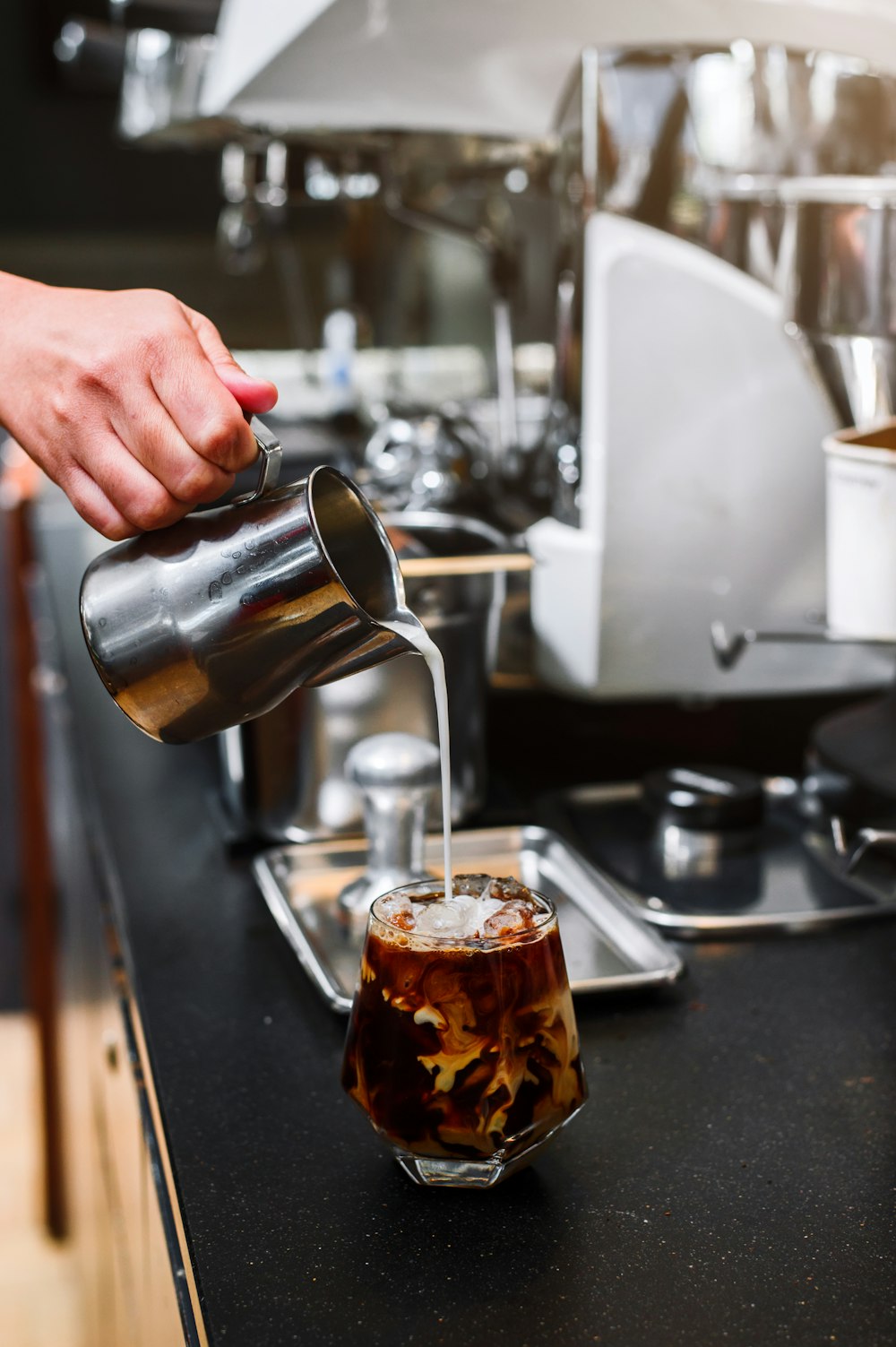 a person pours a beverage into a glass