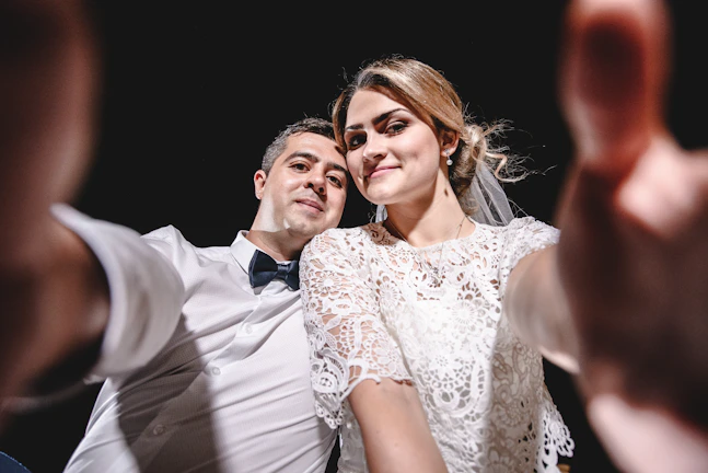 a bride and groom taking a selfie together
