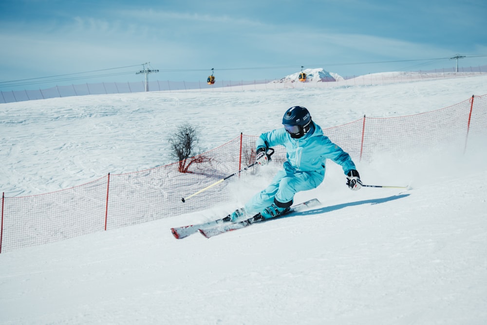 a person on skis going down a snowy hill