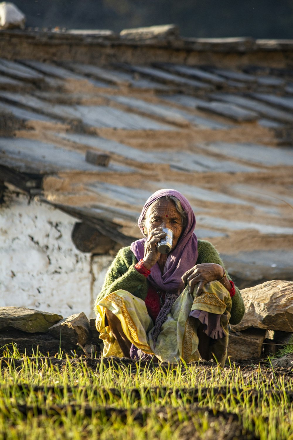a woman sitting on the ground eating something