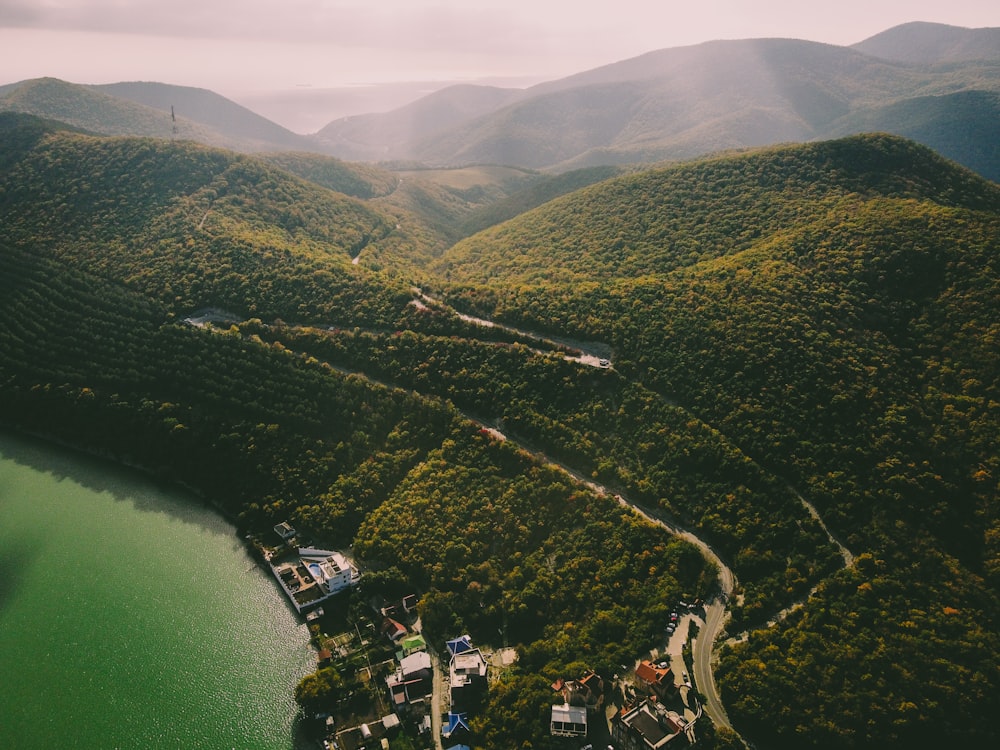 an aerial view of a green valley with a river running through it