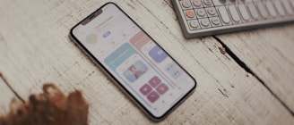 a cell phone sitting on top of a wooden table