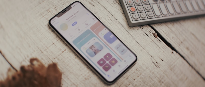 a cell phone sitting on top of a wooden table