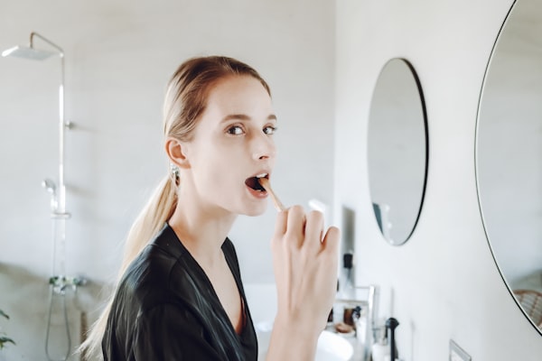 Person brushing teeth as part of daily oral hygiene routine