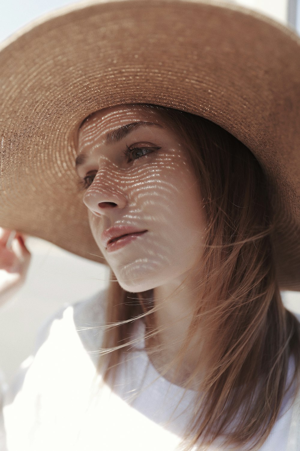 a woman wearing a large brown hat