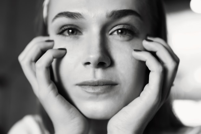 A close-up portrait of a solitary figure with a blurred background, evoking deep emotional tension.