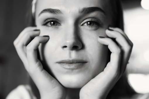 A striking black and white portrait of a person lost in thought, showcasing deep emotion.