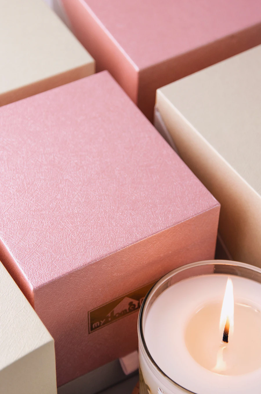 Peony and blush rose soy wax candle beside a blush gift box