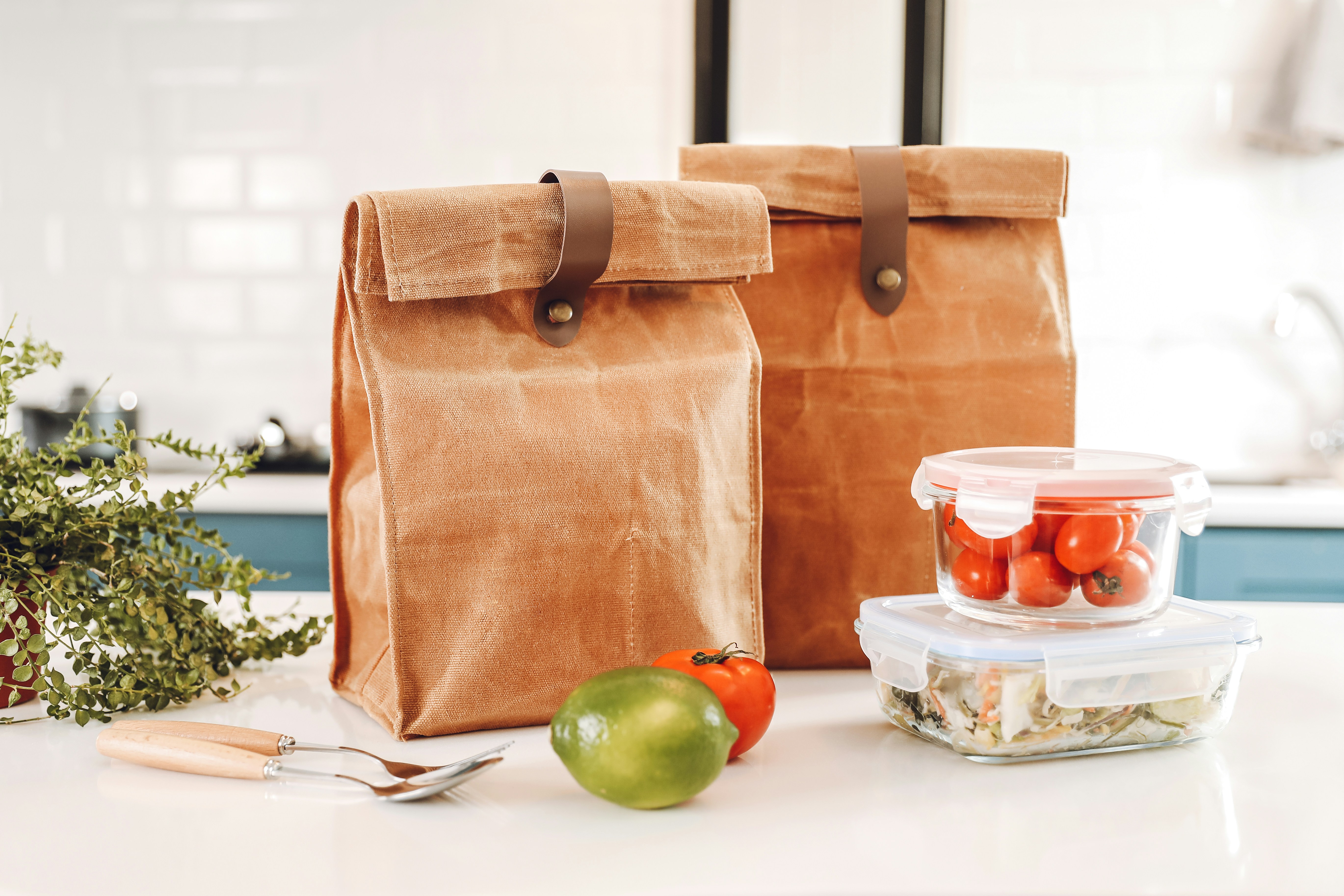 Packed Lunch In A Brown Paper Bag On A Desk With Healthy Meal Prep Containers And A Calendar Marking A Month-long Challenge