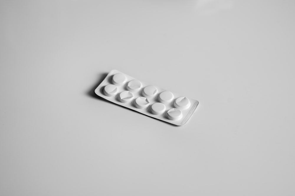 a white pill pill case sitting on top of a table