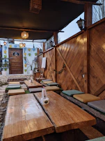 Outdoor setup of an Arabic tent with decorative lanterns and comfortable seating.