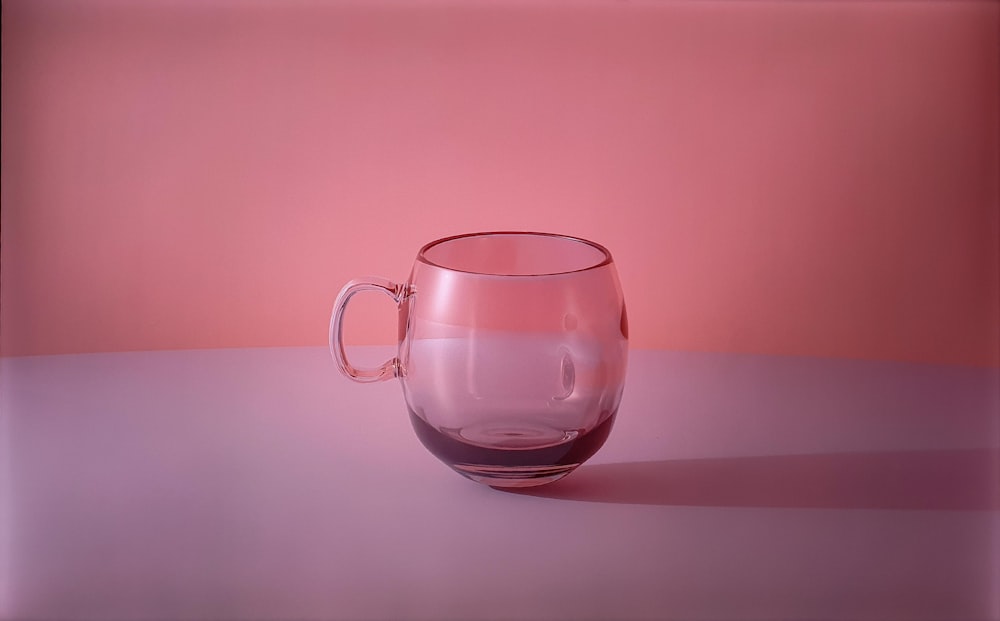 a glass cup sitting on top of a table