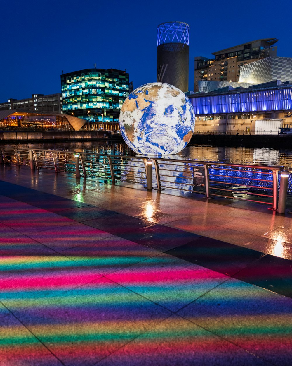 a colorful walkway next to a body of water