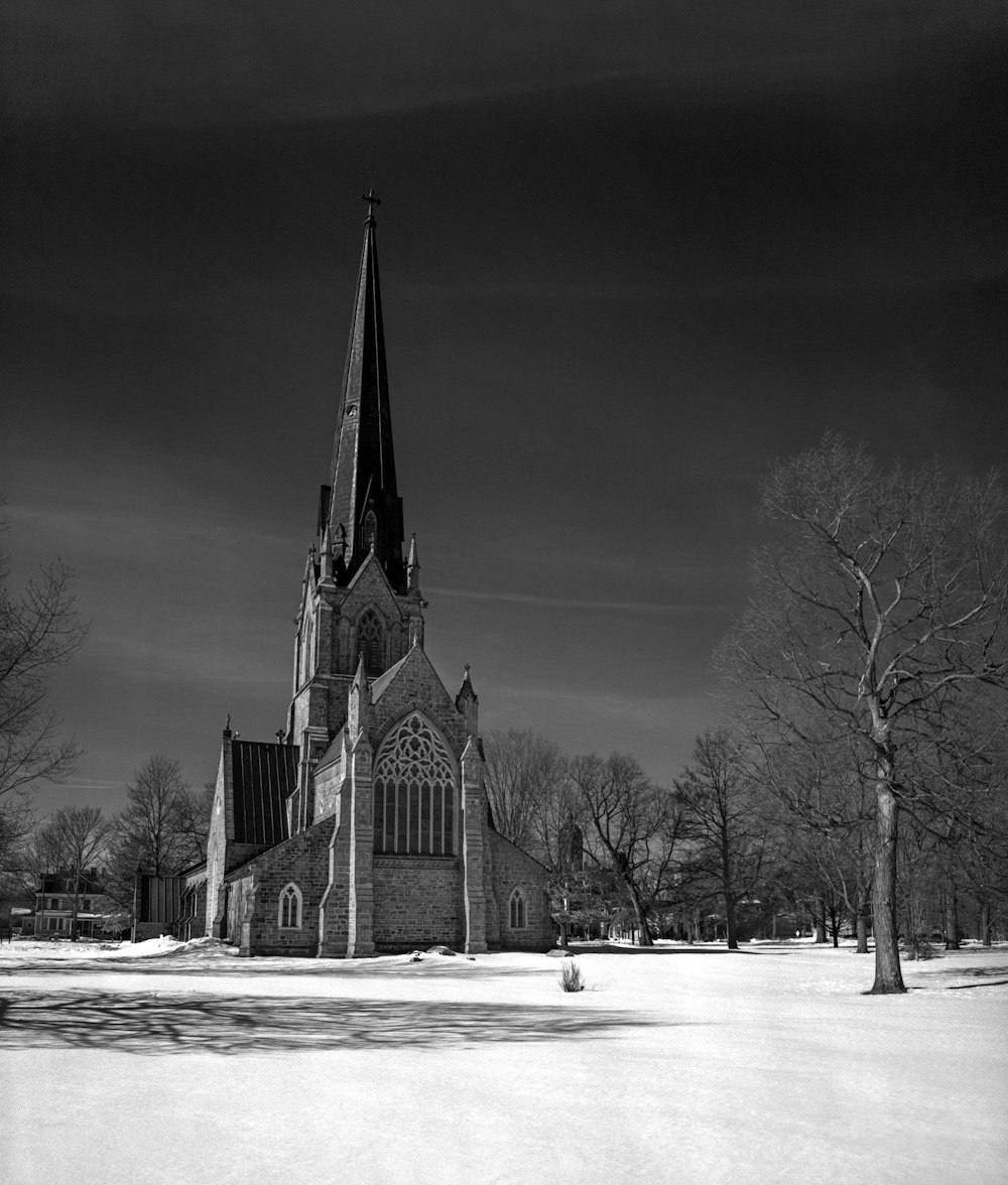 a black and white photo of a church in the snow